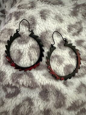 Saw movie hoop earrings. Jagged black with blood stains.
